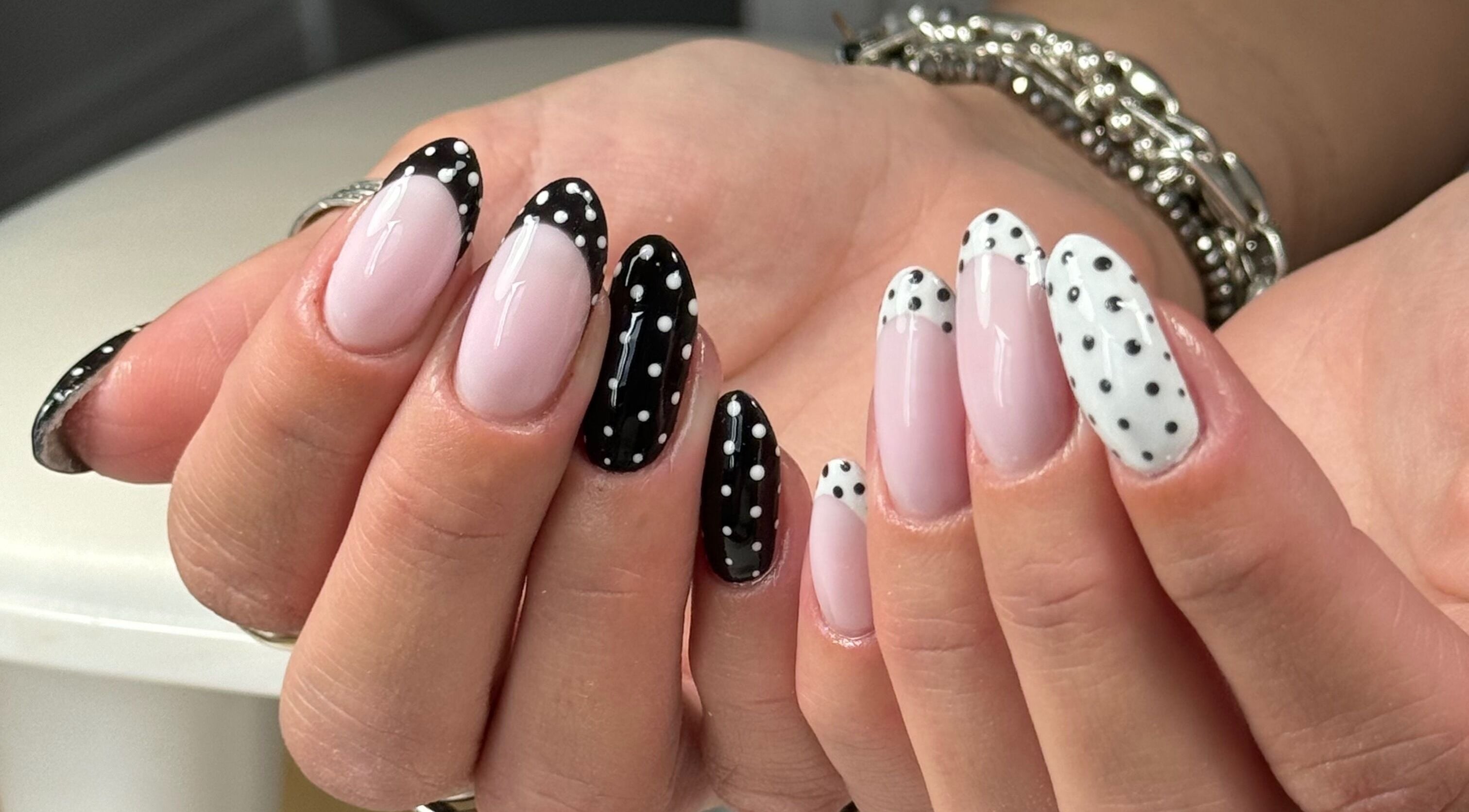Elegant polka dot manicure at Freshsetcait in Colchester, England, GB. Black and white nail art design.