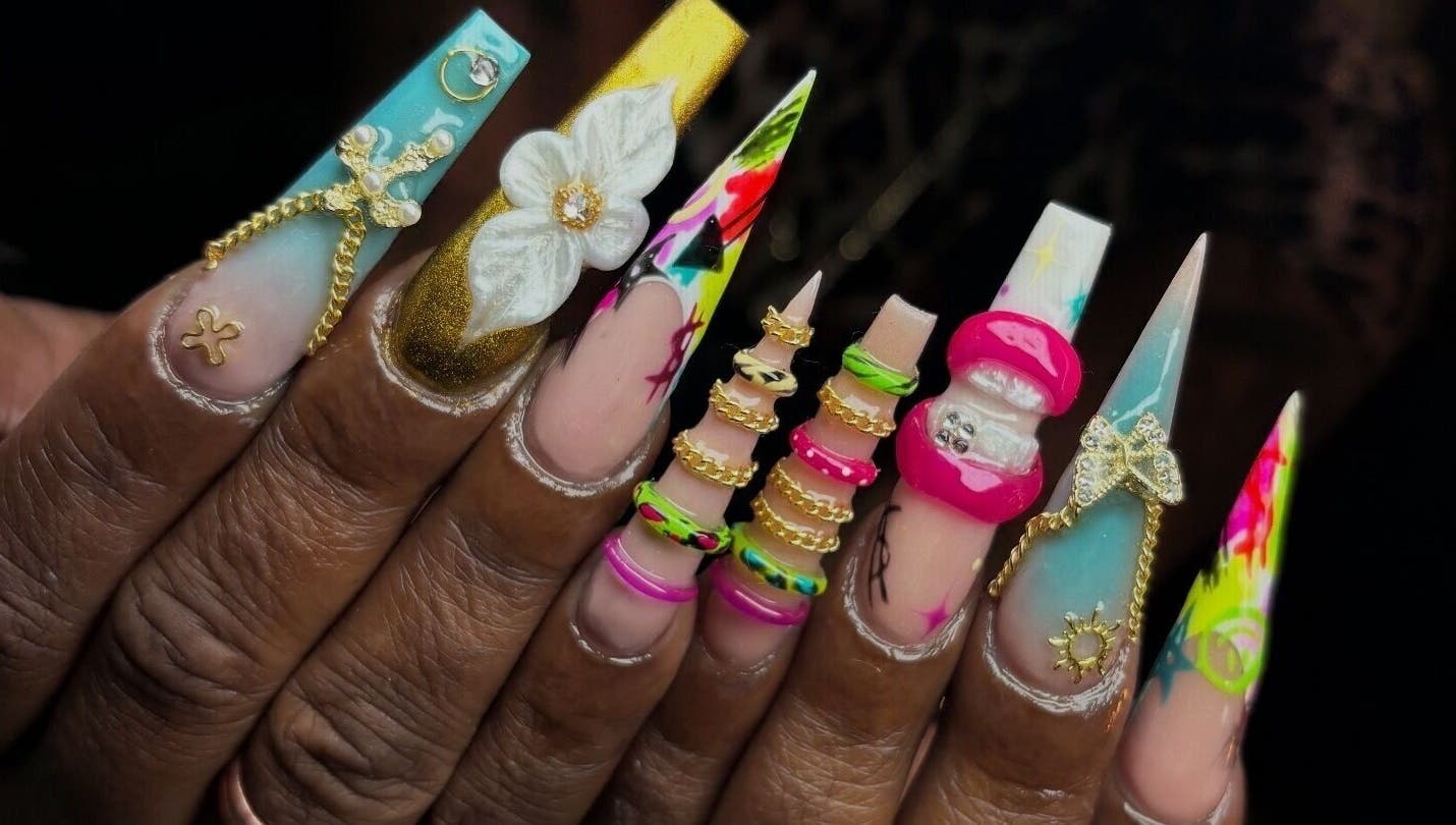 Intricate nail art with 3D embellishments at NSNails+ in Tampa, Florida, US, showcasing vibrant designs.