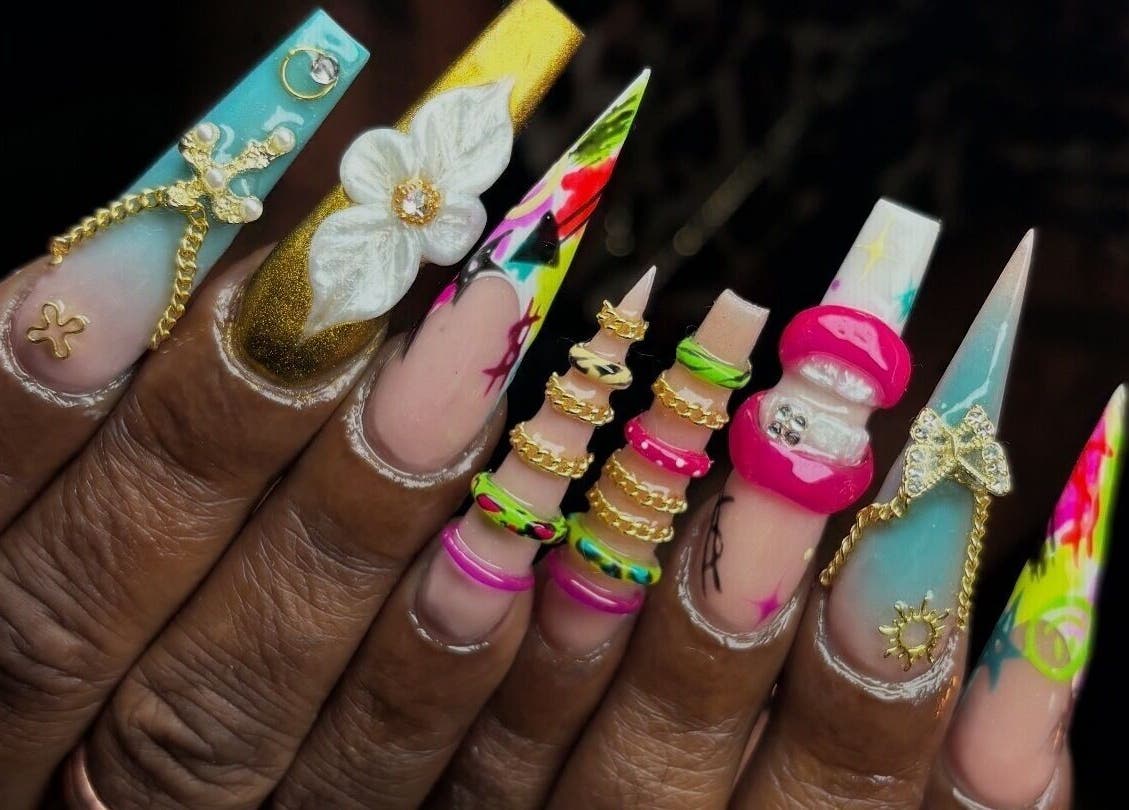 Intricate nail art with 3D embellishments at NSNails+ in Tampa, Florida, US, showcasing vibrant designs.
