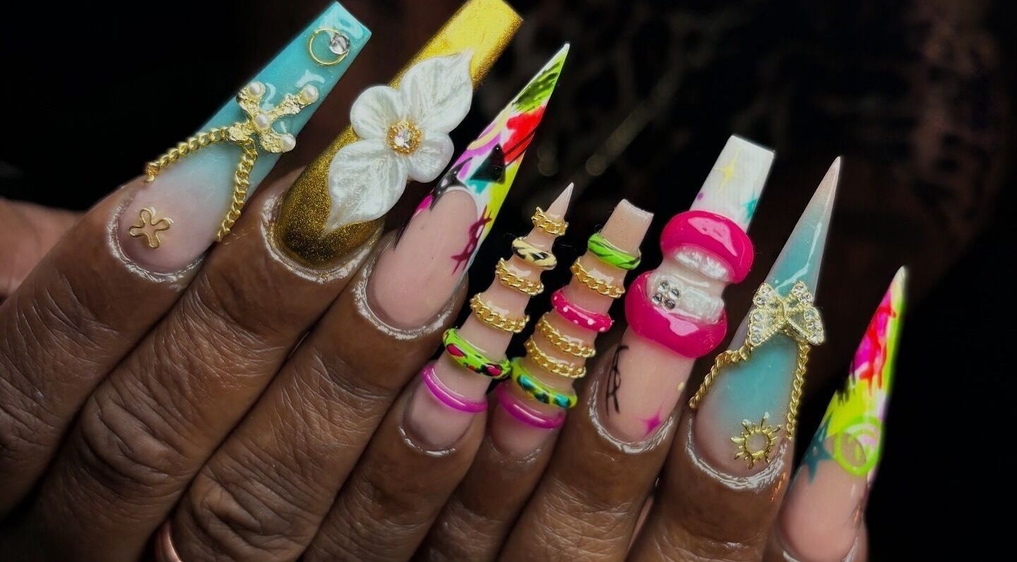 Intricate nail art with 3D embellishments at NSNails+ in Tampa, Florida, US, showcasing vibrant designs.