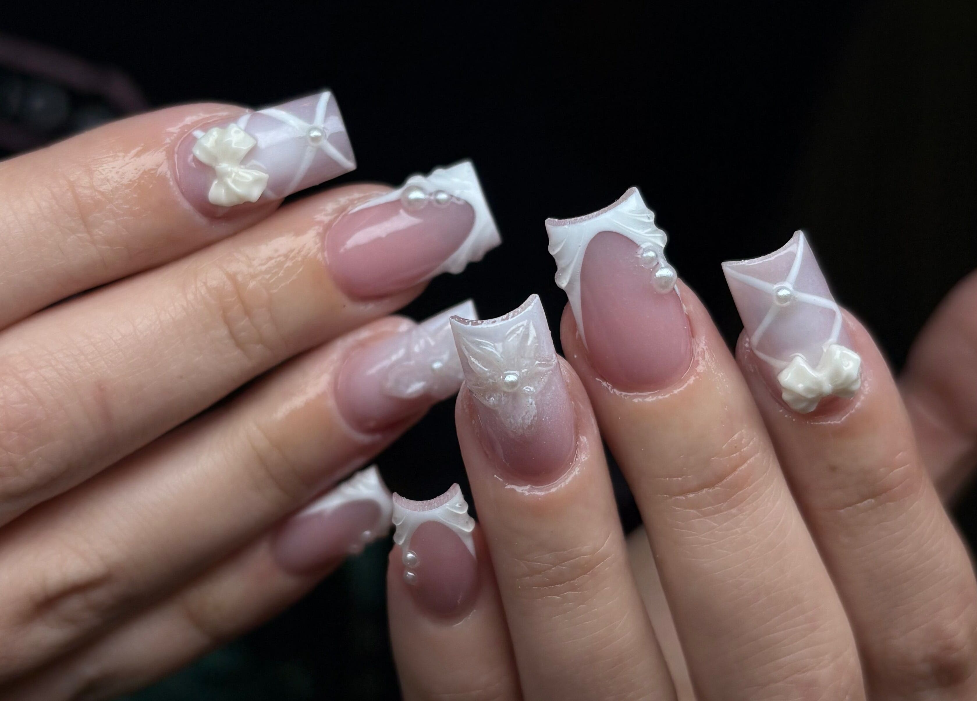 Intricate 3D nail art featuring bows and pearls at NSNails+ in Tampa, Florida, US.
