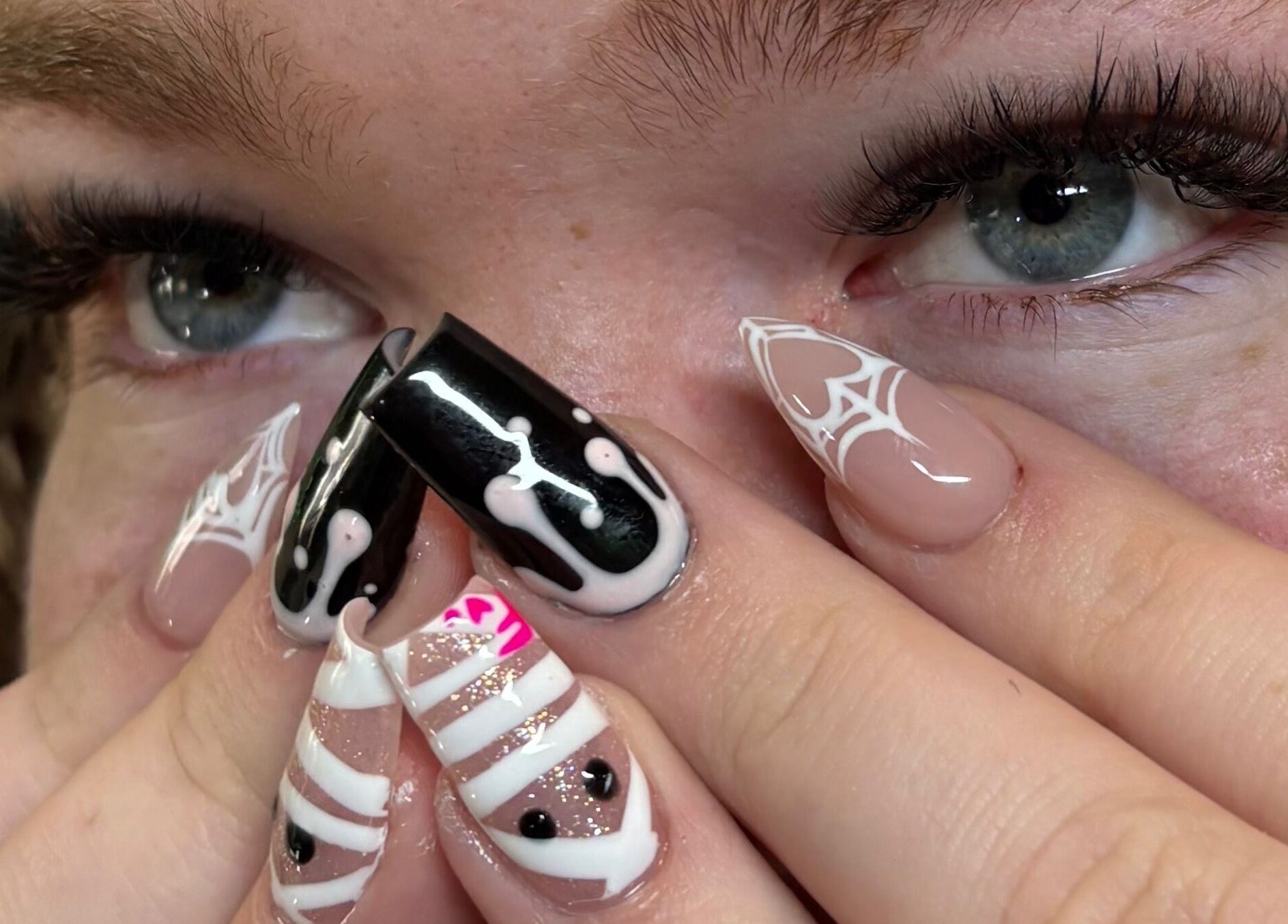 Close-up of intricate gothic nail art at NSNails+ in Tampa, Florida, US with black and white patterns.