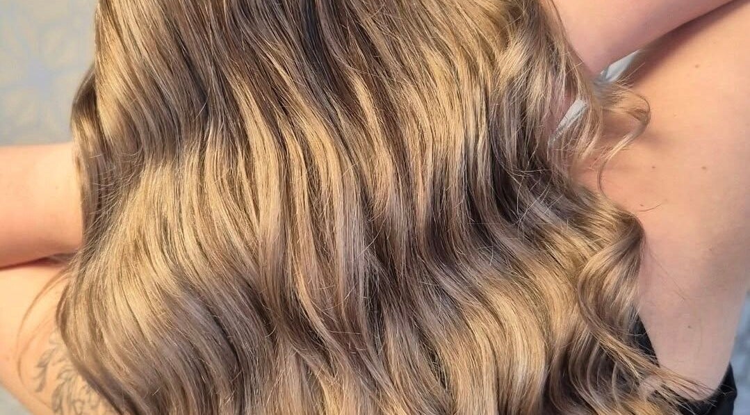 Lustrous blonde waves at Sally Sweethearts, Halesowen, England, GB, showcasing professional hair styling.