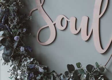 Floral decor under 'Soul' sign at Kelly at Soul Self Care Clinic, Harrogate, England, GB.