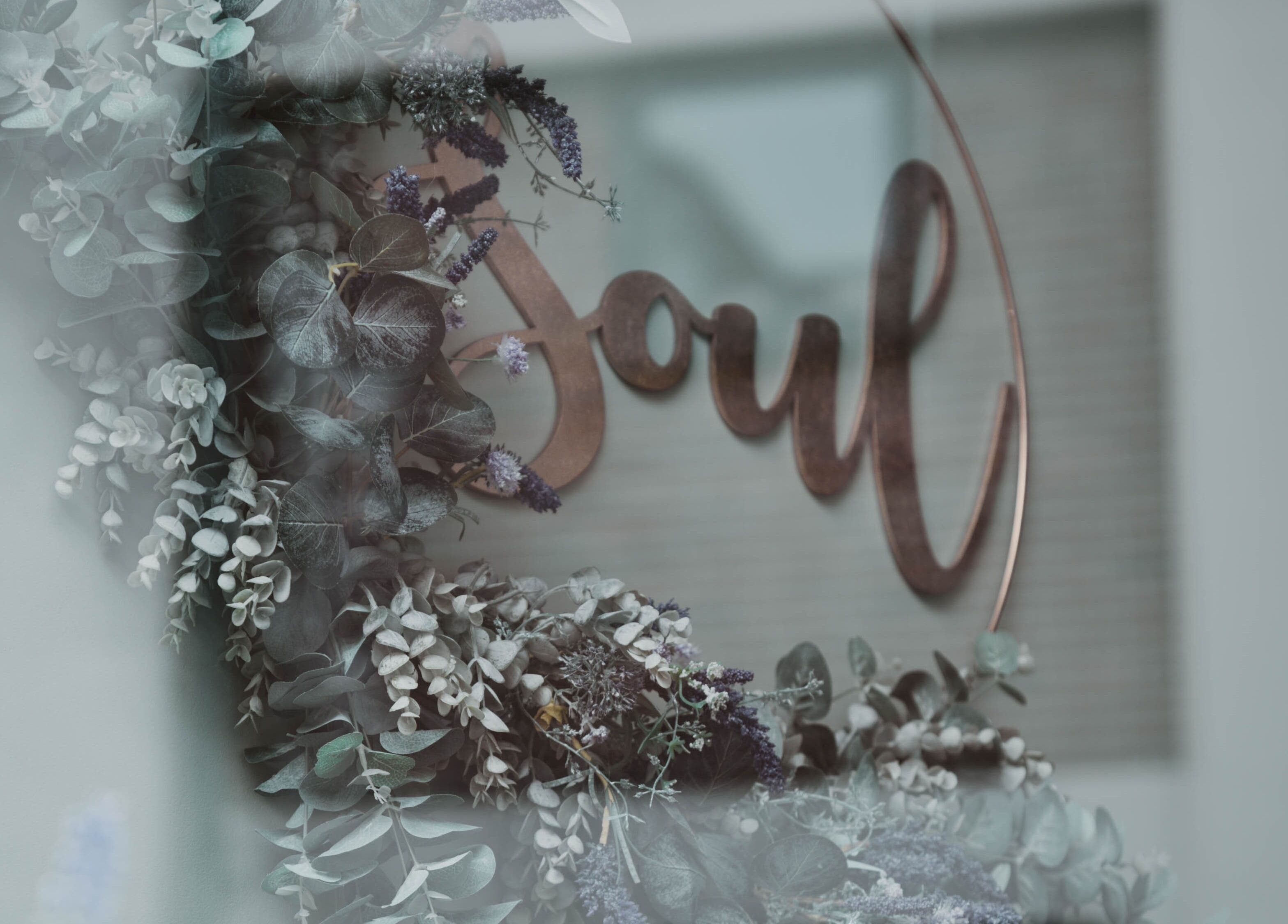 Floral decor and 'Soul' sign near Kelly at Soul Self Care Clinic in Harrogate, England, GB.