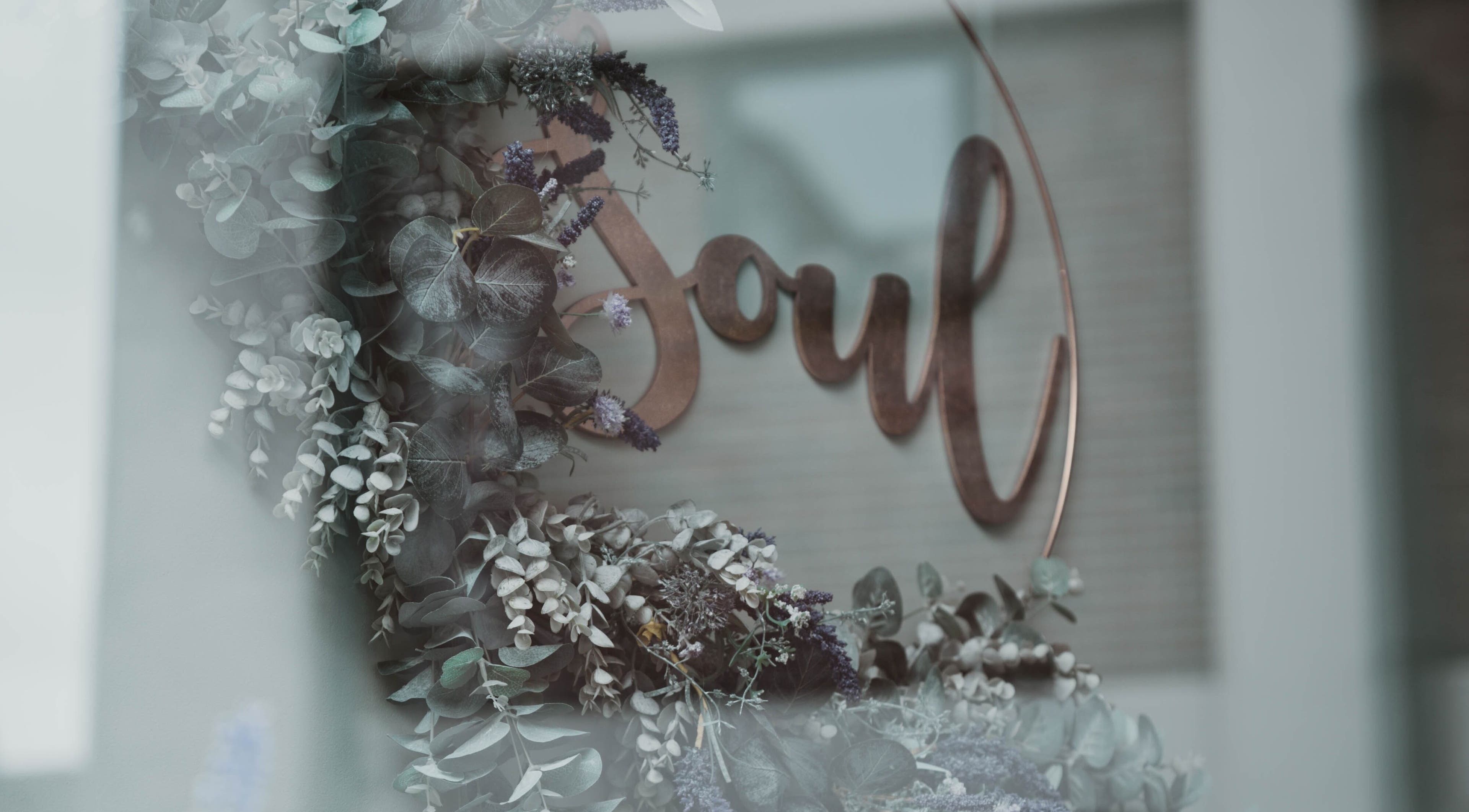 Floral decor and 'Soul' sign near Kelly at Soul Self Care Clinic in Harrogate, England, GB.