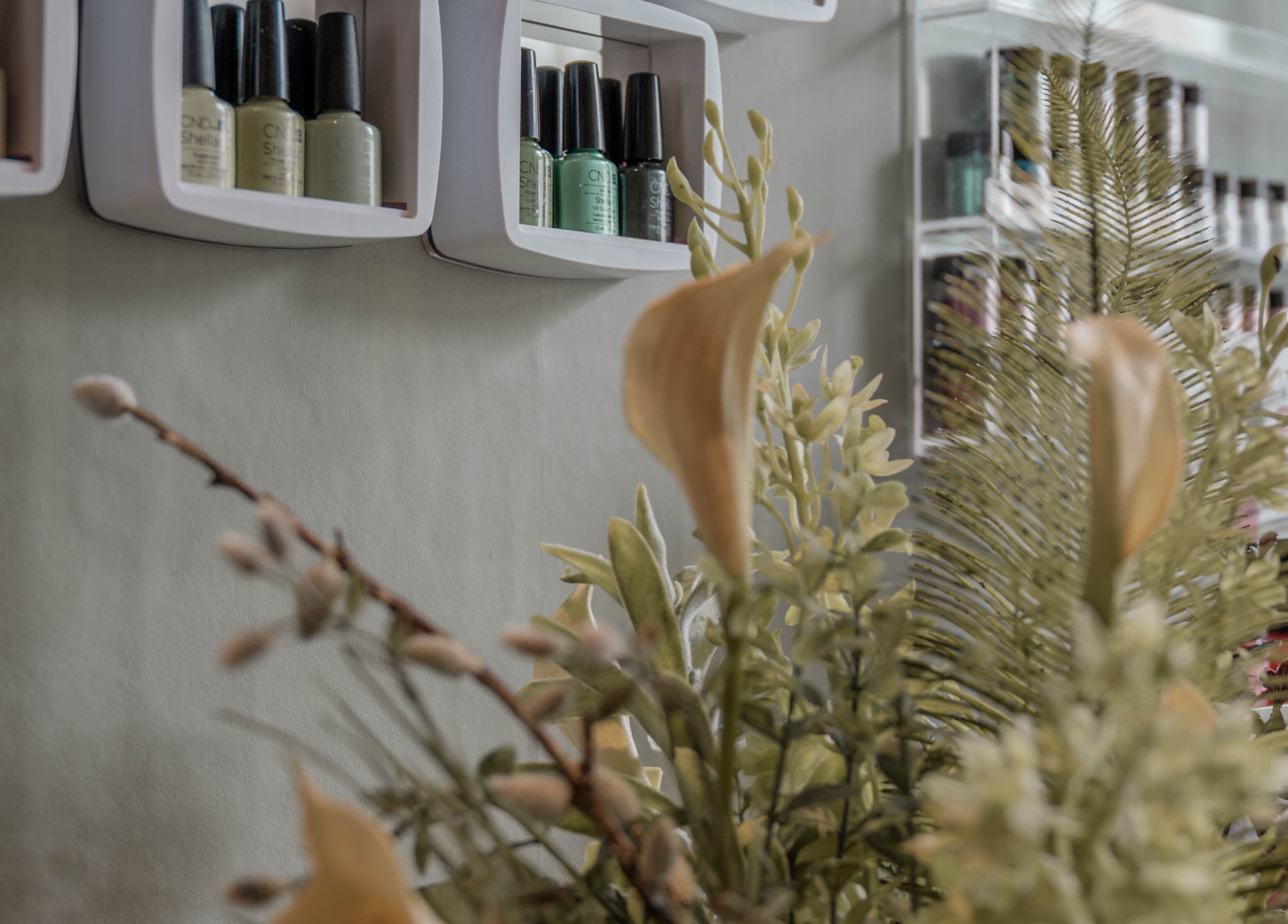Nail polish and floral display at Kelly at Soul Self Care Clinic, Harrogate, England, GB.