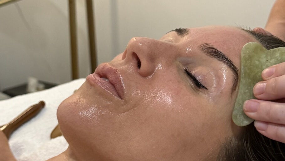 Rejuvenating facial massage using gua sha tool at Bae Aesthetic Studio in Rothwell, Queensland, AU.