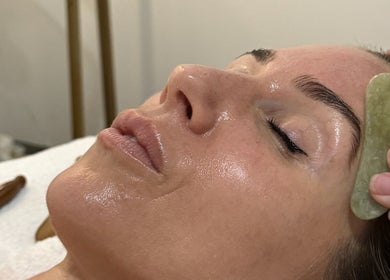 Rejuvenating facial massage using gua sha tool at Bae Aesthetic Studio in Rothwell, Queensland, AU.