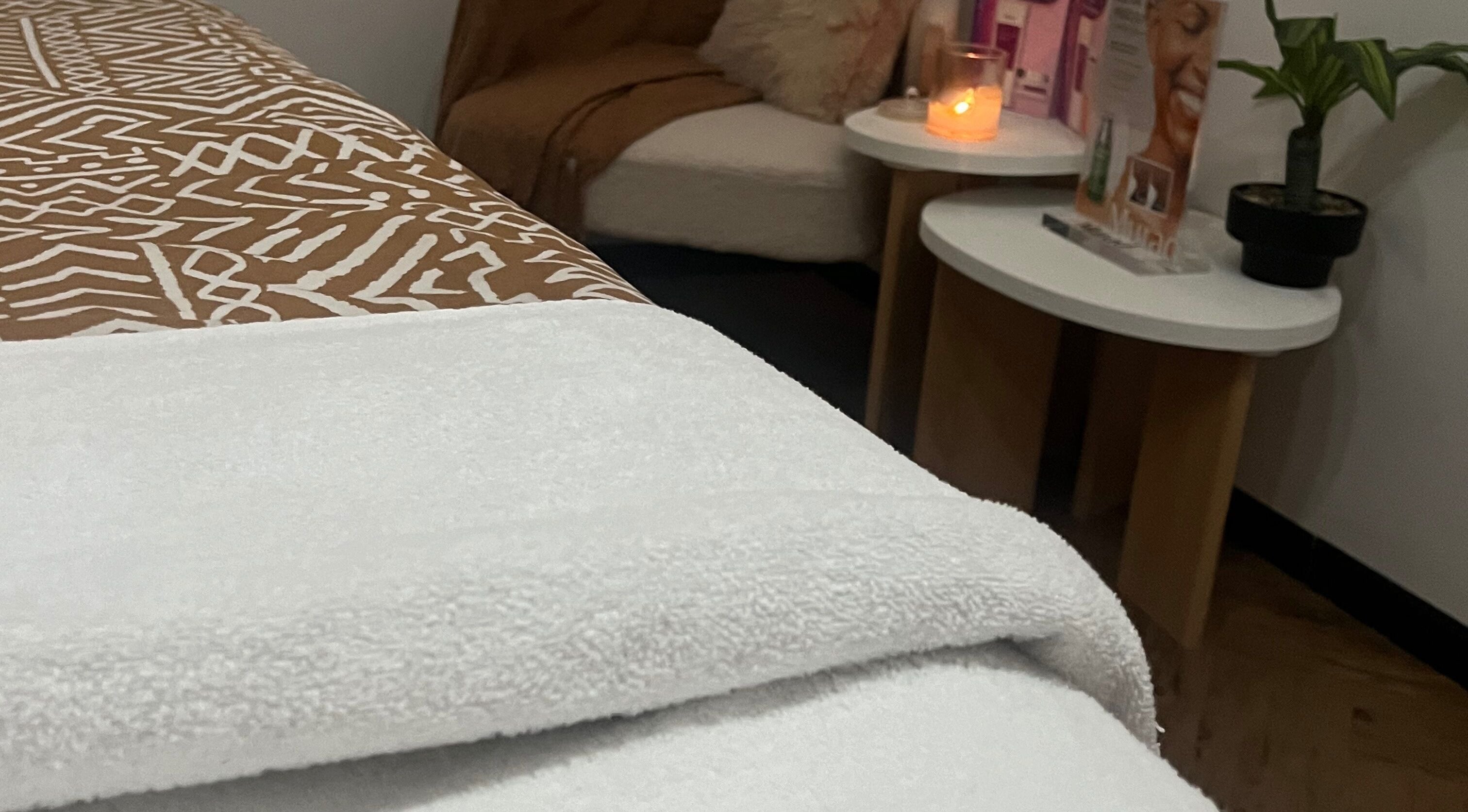 Relaxing treatment room at Bae Aesthetic Studio, Rothwell, Queensland, AU with warm lighting and plush decor.