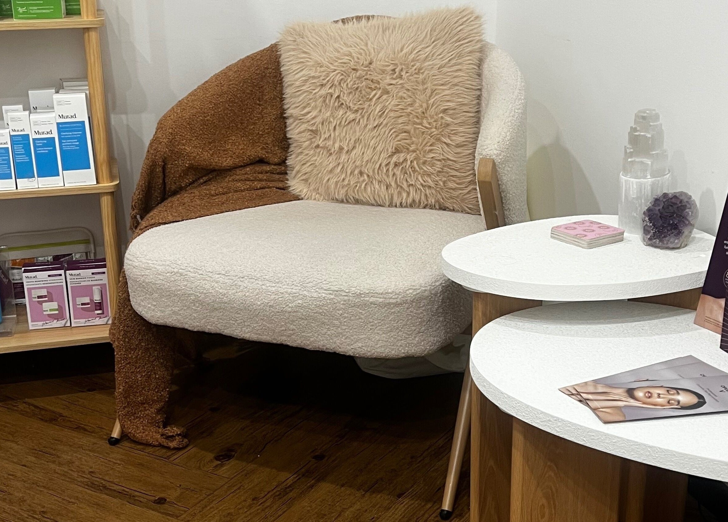 Relaxing skincare corner at Bae Aesthetic Studio, Rothwell, Queensland, AU with plush seating and beauty products.