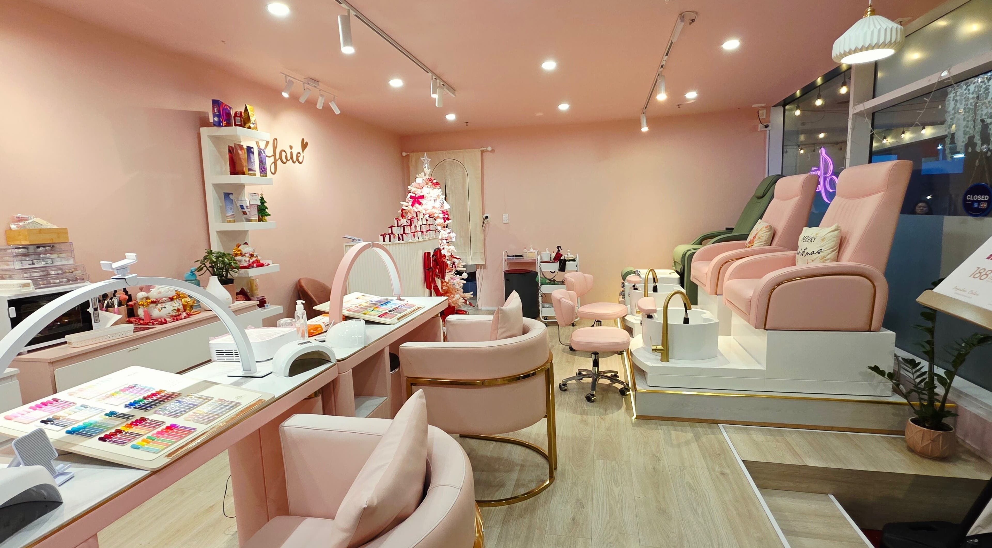 JoiE Beauty Salon in Auckland, NZ with elegant pink decor and plush seating for a luxurious experience.
