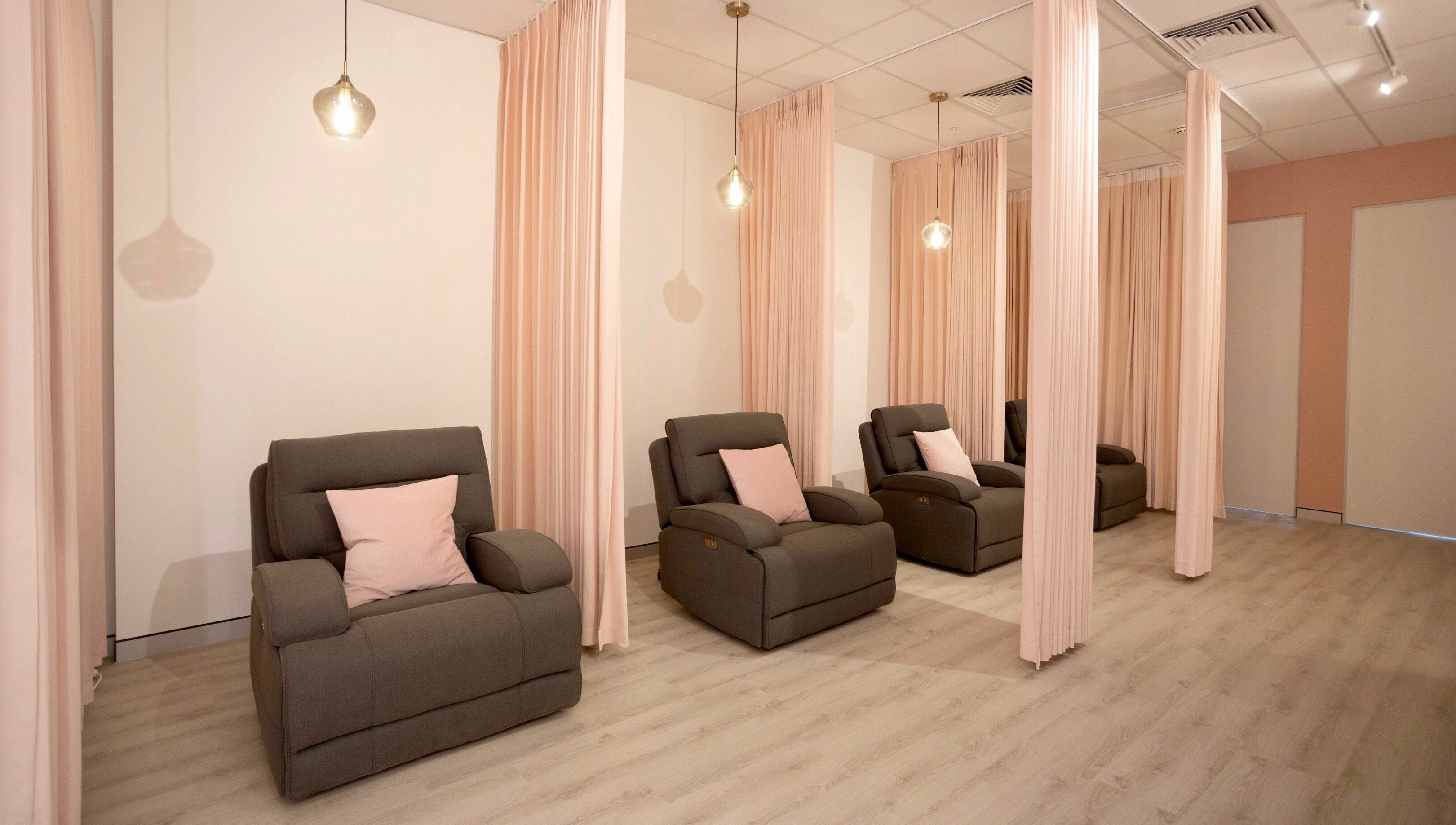 Relaxing lounge chairs with soft lighting at S&L Skins and Lashes, Burwood, New South Wales, AU.