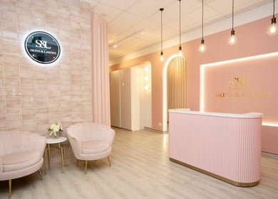 Chic reception at S&L Skins Beauty, Sydney, New South Wales, AU with elegant pink decor and plush seating.