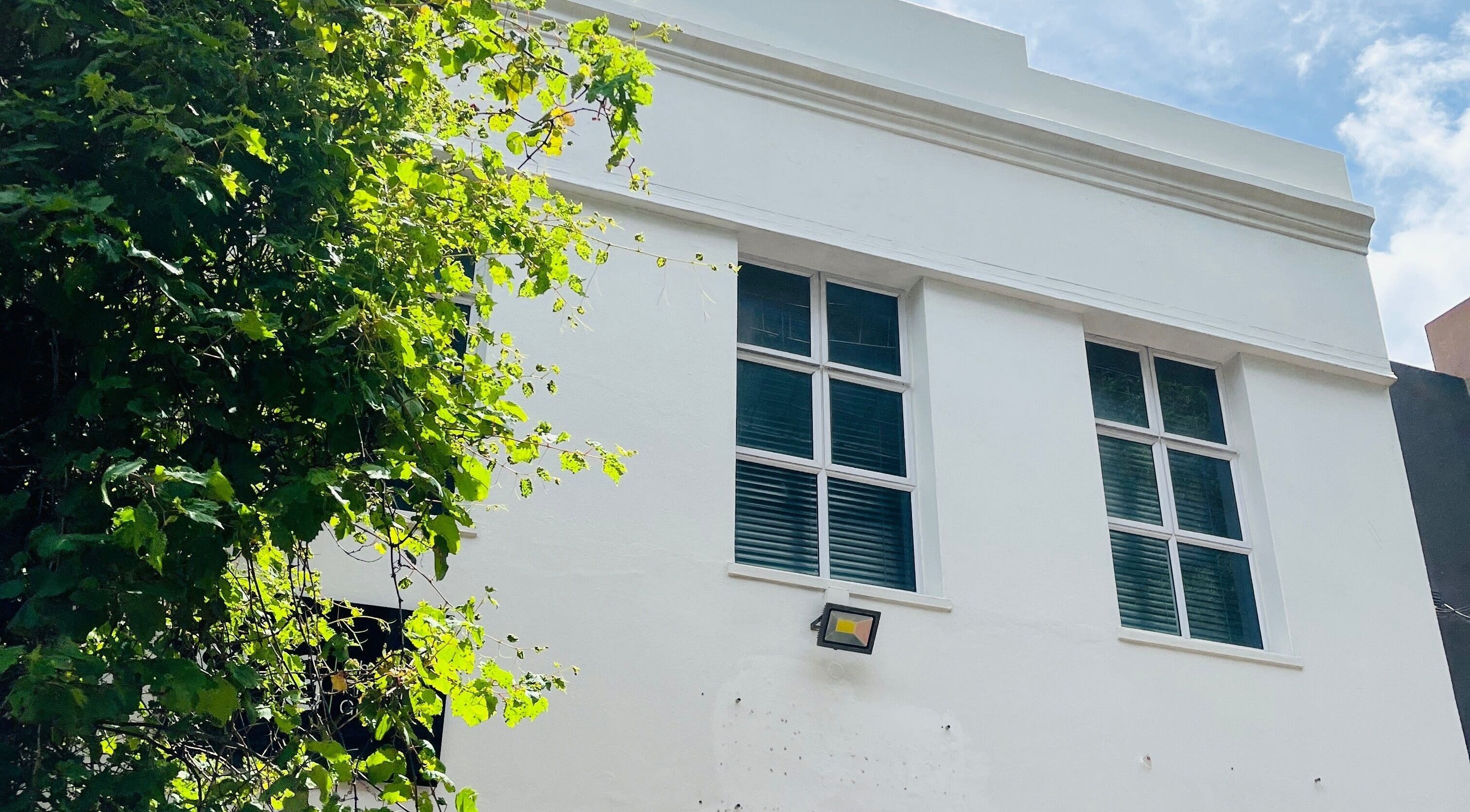 Exterior of Liliy Nails Beauty Studio in Cape Town, Western Cape, ZA with bright windows and greenery.