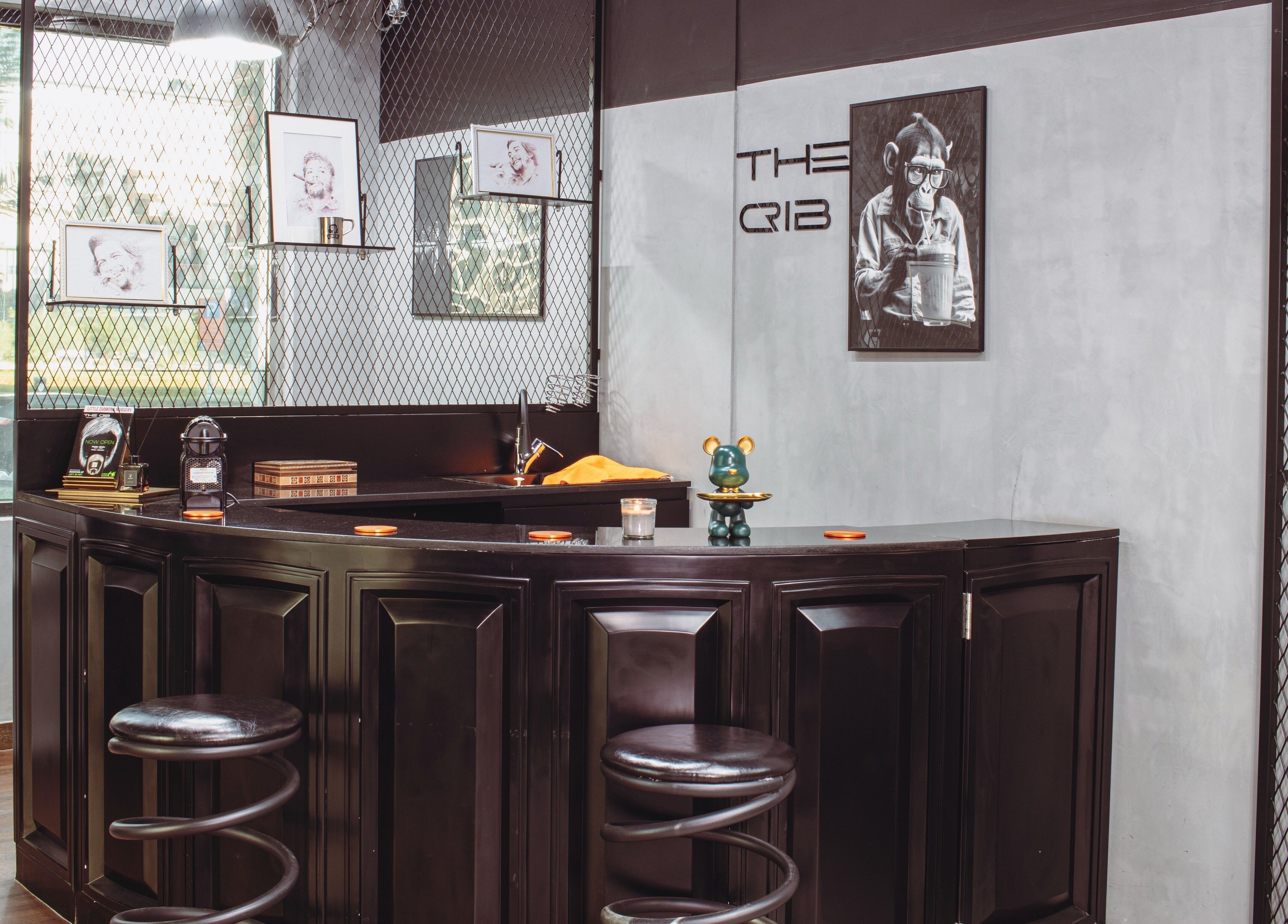 Stylish interior of The Crib Barbershop in Arjan, Dubai, AE with modern decor and artwork.