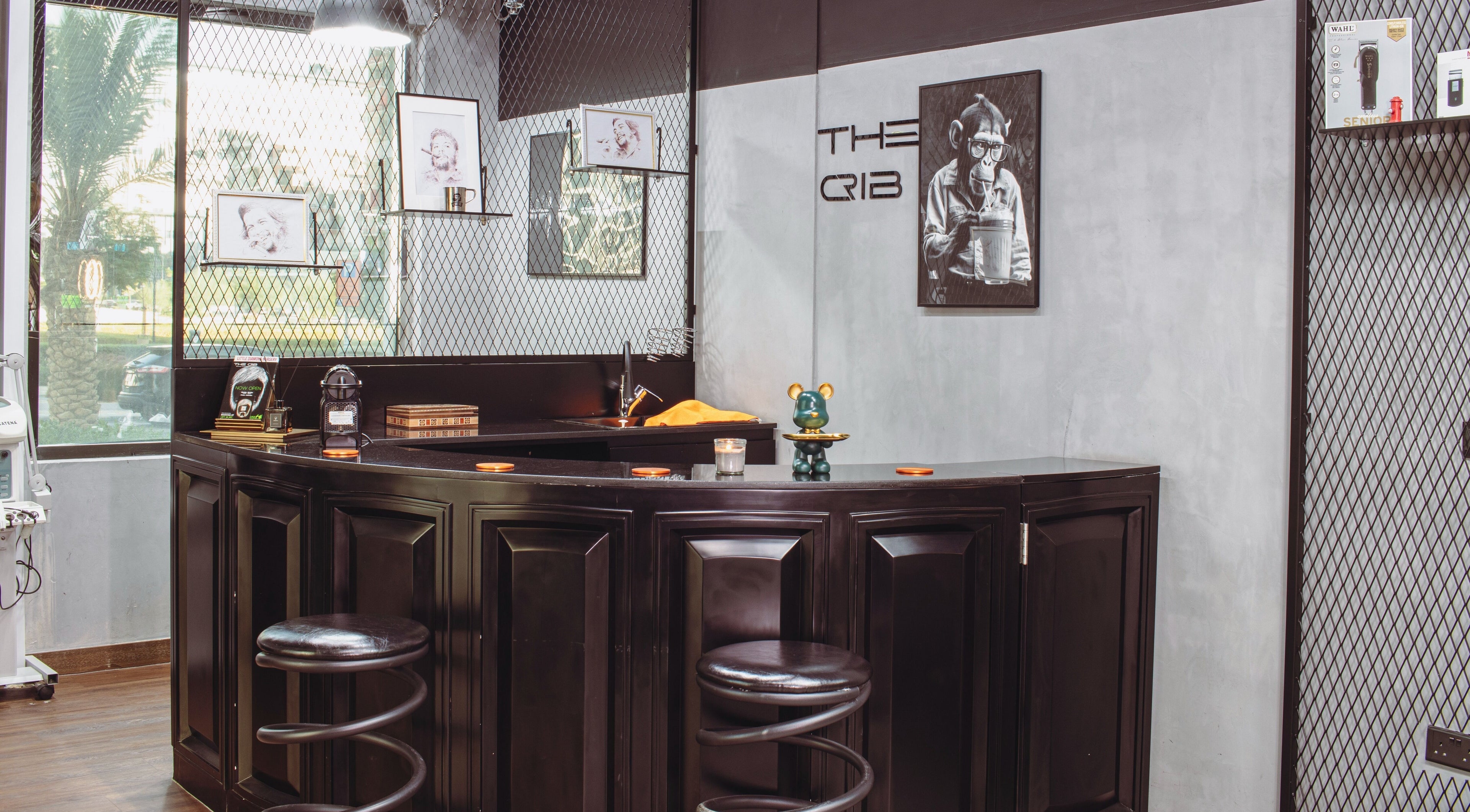 Stylish interior of The Crib Barbershop in Arjan, Dubai, AE with modern decor and artwork.