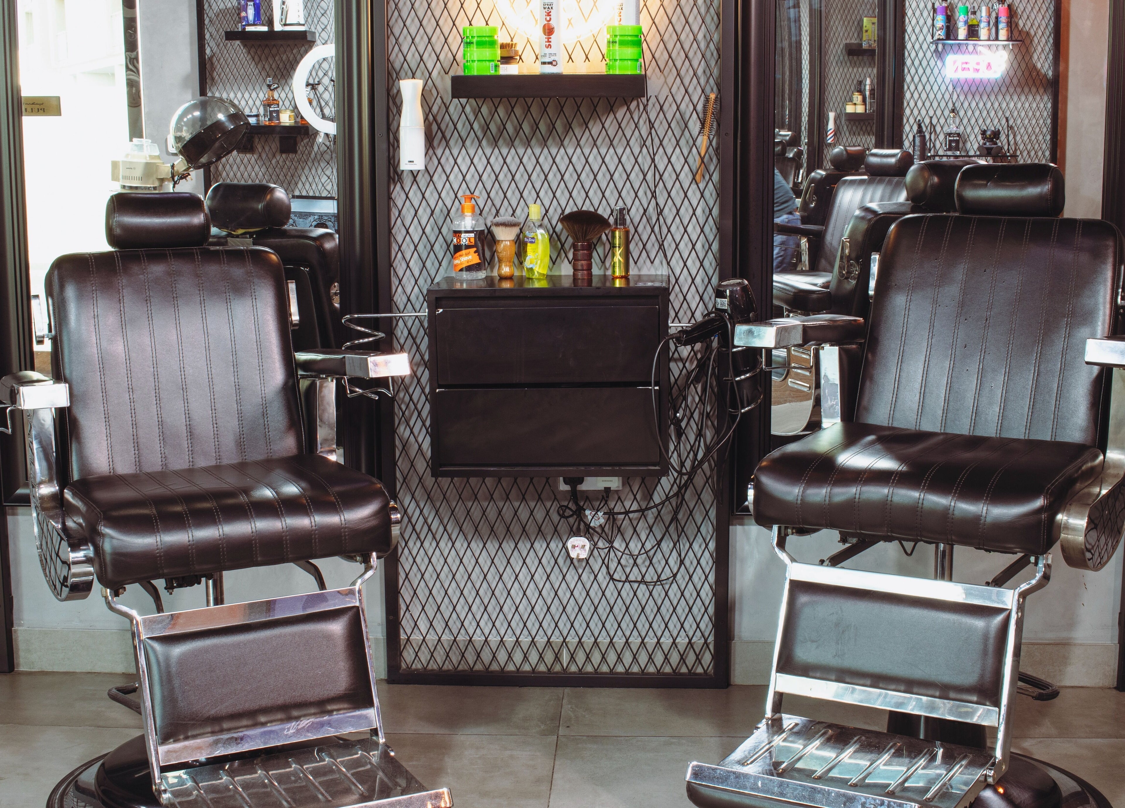 Luxurious barber chairs at The Crib Barbershop in Arjan, Dubai, AE, showcasing a modern and sleek design.
