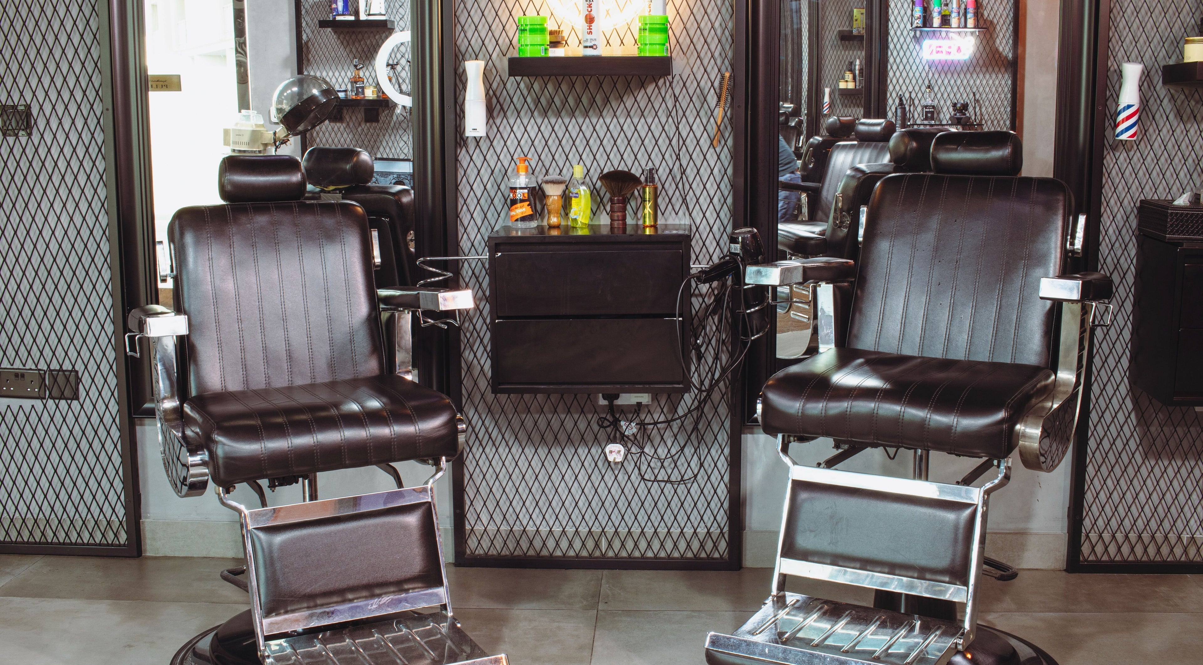 Luxurious barber chairs at The Crib Barbershop in Arjan, Dubai, AE, showcasing a modern and sleek design.
