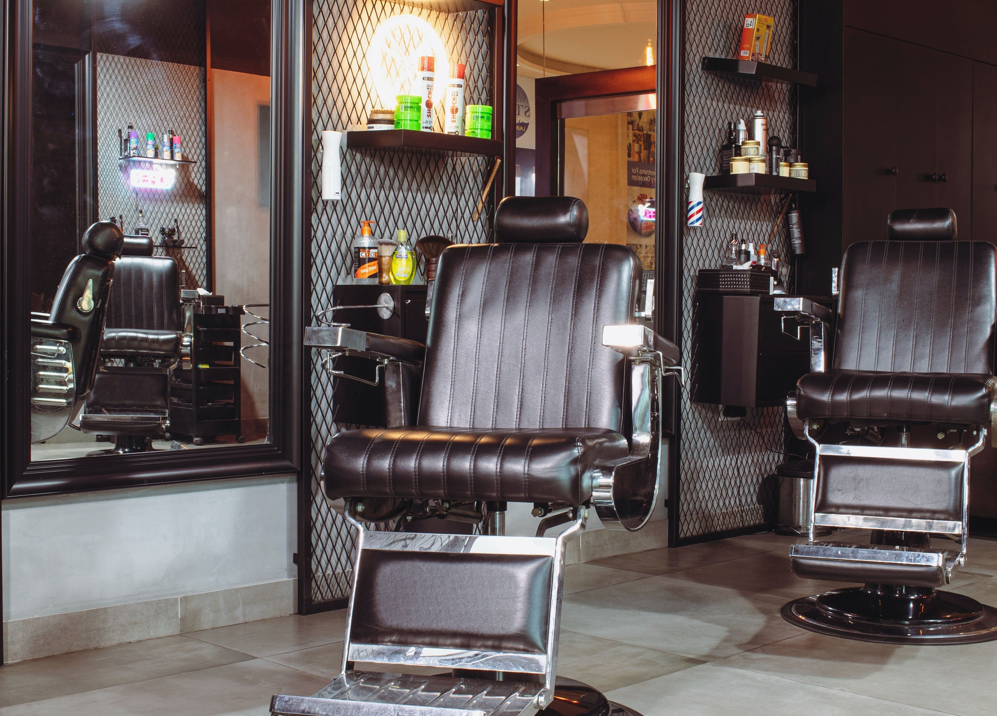Chic barber chairs at The Crib Barbershop, Arjan, Dubai, AE, offering a stylish grooming experience.