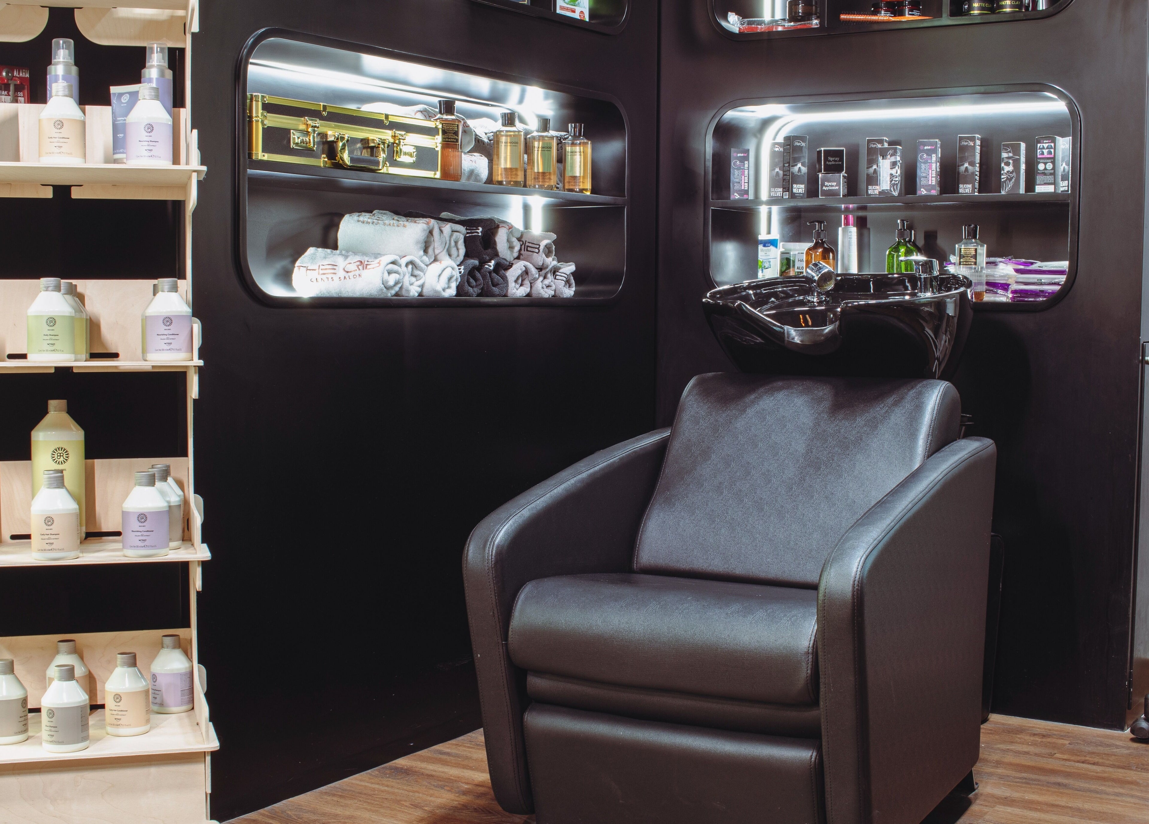 Elegant barber chair and products at The Crib Barbershop, Arjan, Dubai, AE. Modern and inviting interior.