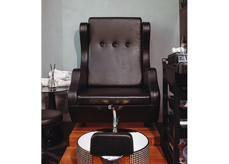 Luxurious pedicure chair at The Crib Barbershop, Arjan, Dubai, AE, offering premium grooming services.