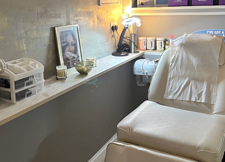 Relaxing treatment room at Naturally U, Sittingbourne, England, GB with a white spa chair and soothing decor.