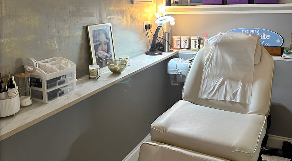 Relaxing treatment room at Naturally U, Sittingbourne, England, GB with a white spa chair and soothing decor.