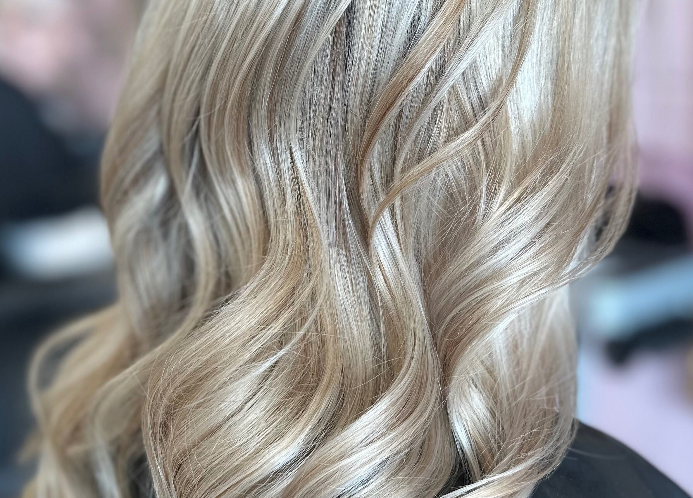 Elegant blonde waves styled at Naturally U in Sittingbourne, England, GB, ideal for a chic look.