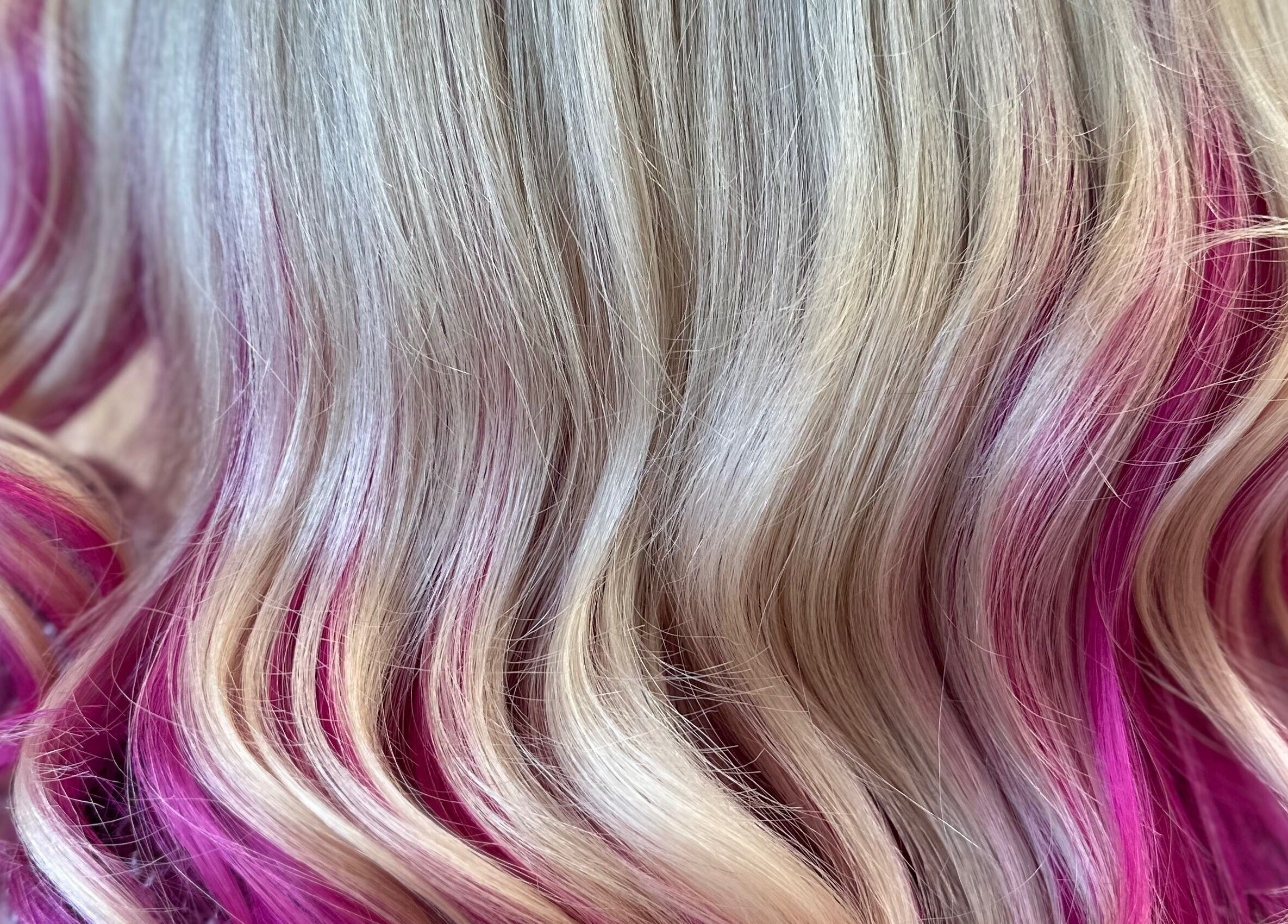 Blonde hair with vibrant pink highlights at Naturally U, Sittingbourne, England, GB.