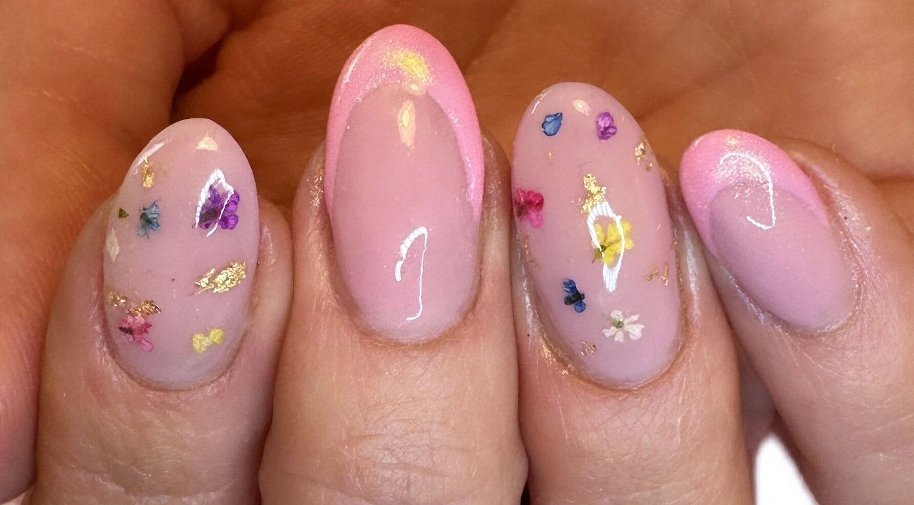 Elegant floral nail art at NML Beauty, Ramsgate, England, GB, showcasing delicate designs on polished nails.