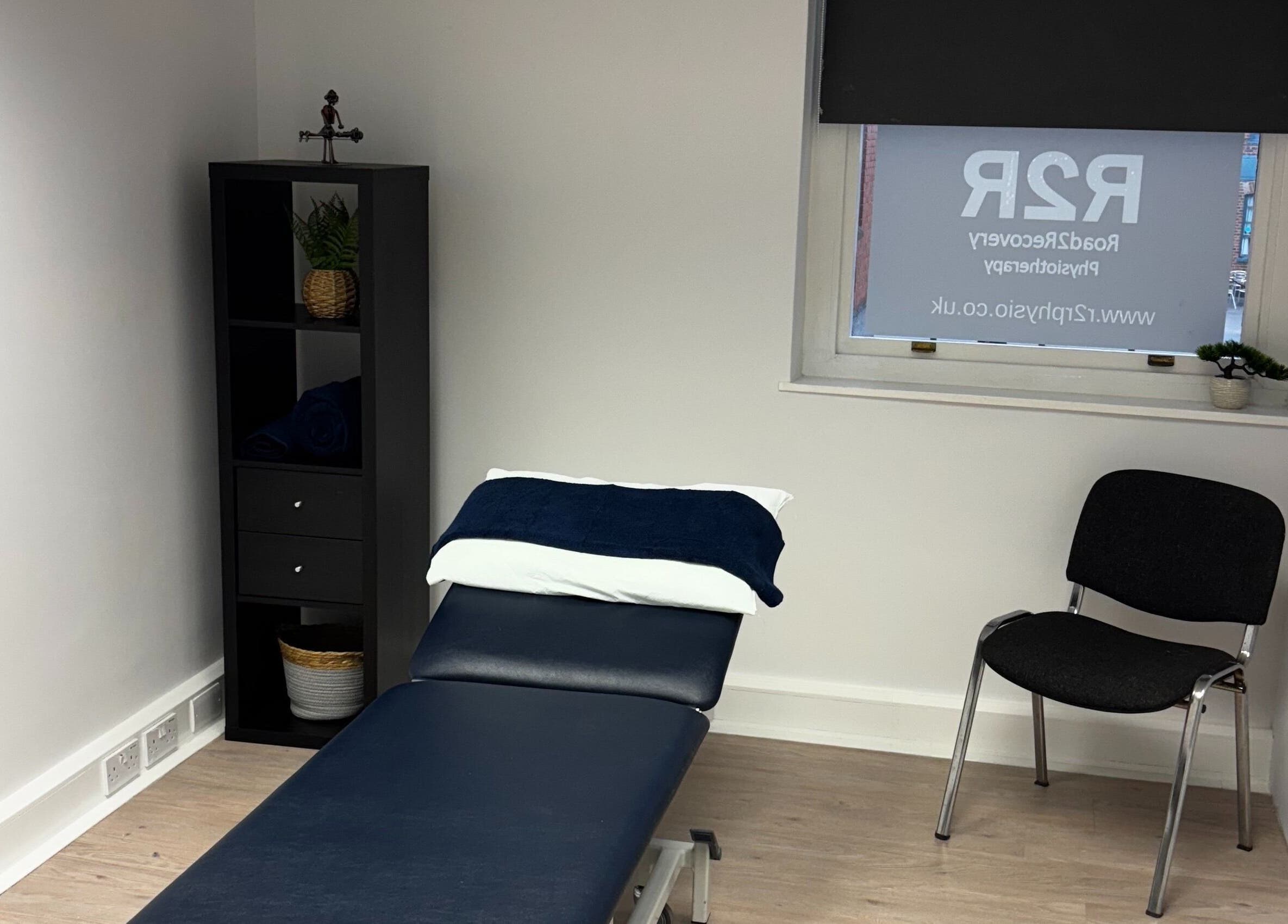 Therapy room at R2R Physiotherapy Braintree, Braintree, England, GB showing a massage table and chair.