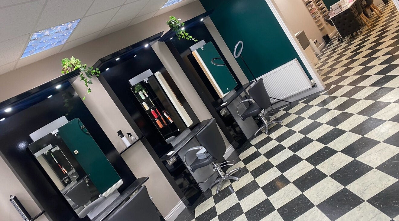 Elegant salon chairs and mirrors inside Ivy Hair & Beauty, Cowdenbeath, Scotland, GB.