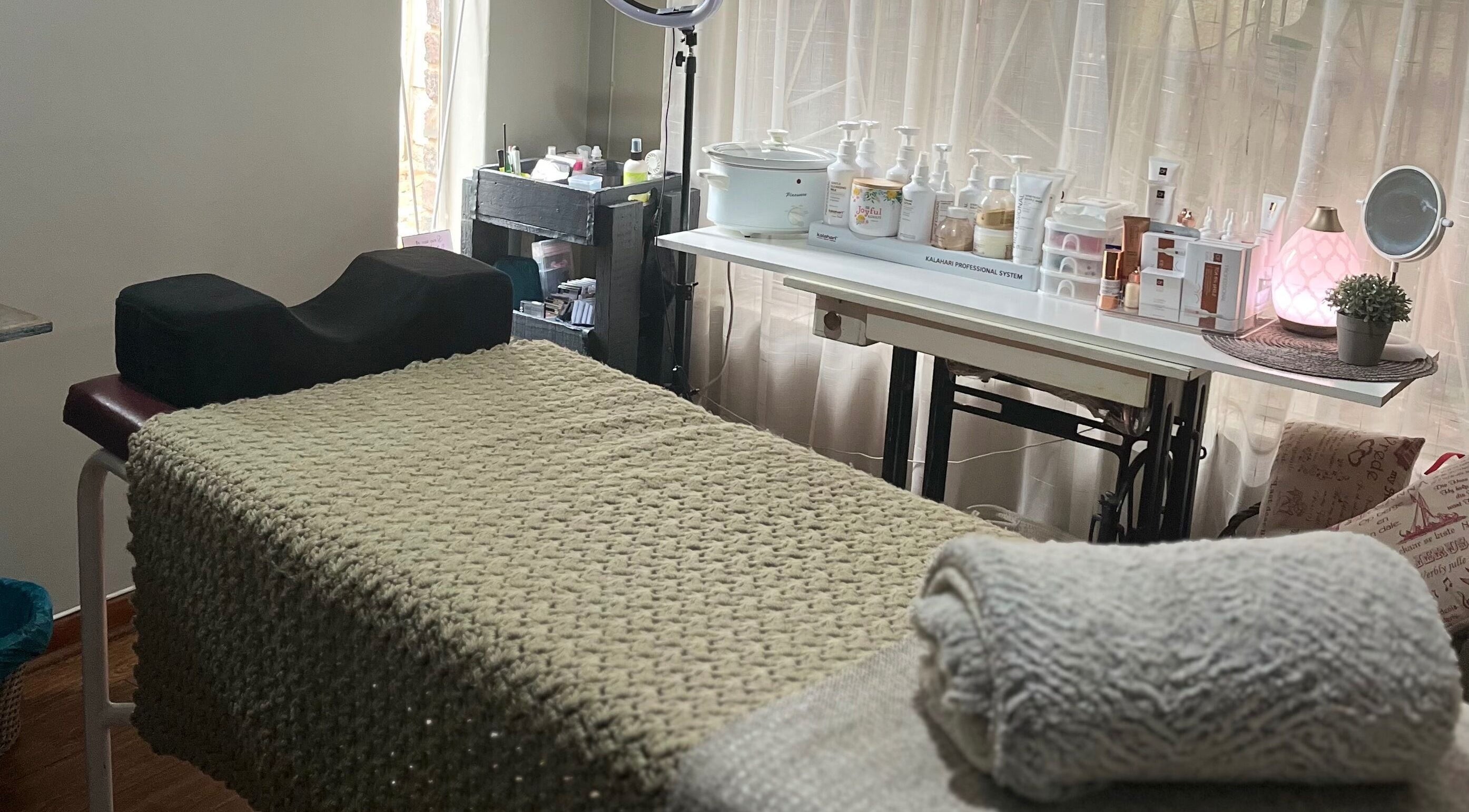 Cozy spa room at Rala Mayer Nail and Beauty, Delmas, Mpumalanga, ZA, featuring treatment bed and beauty products.