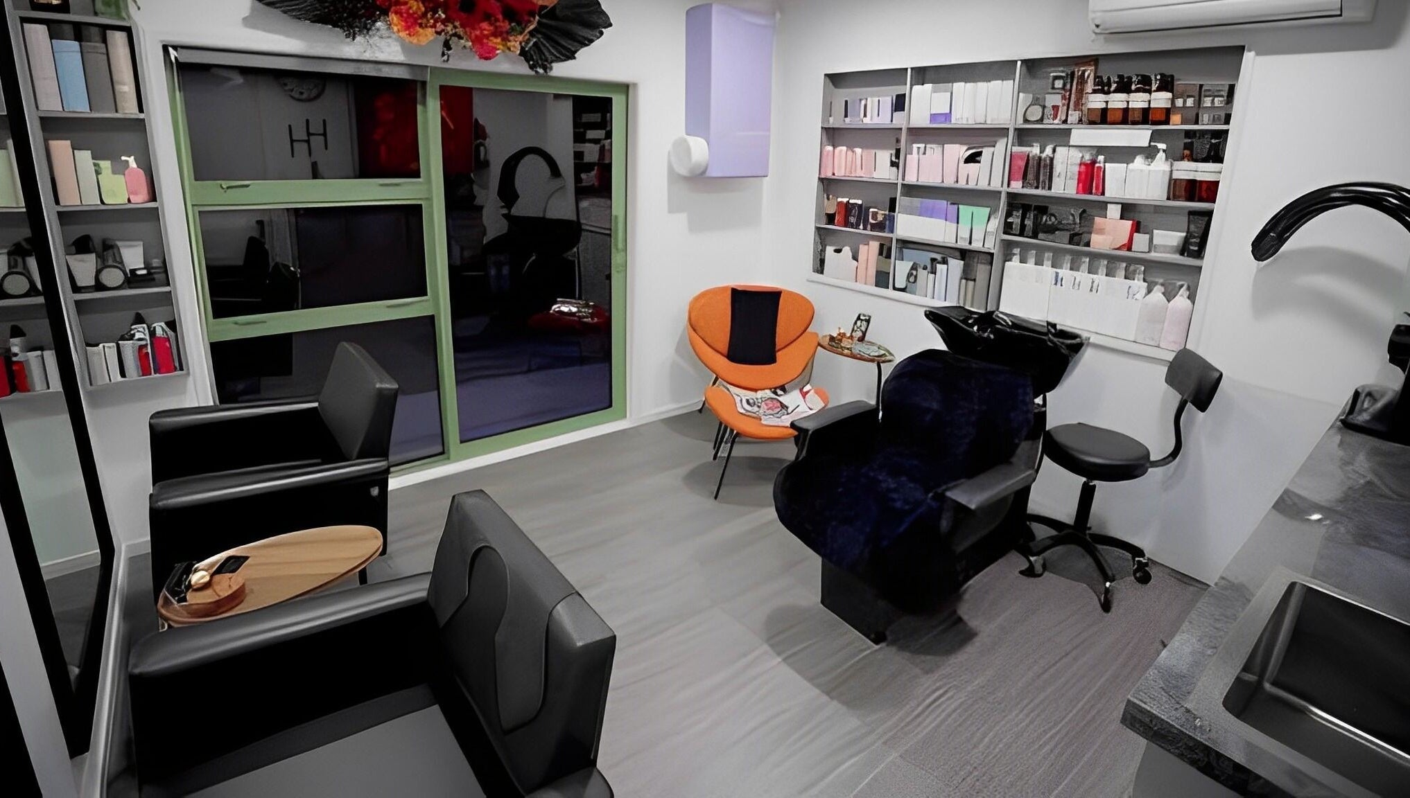 Modern interior of Hair by Hina Limited in Auckland, NZ, featuring sleek chairs and vibrant decor.