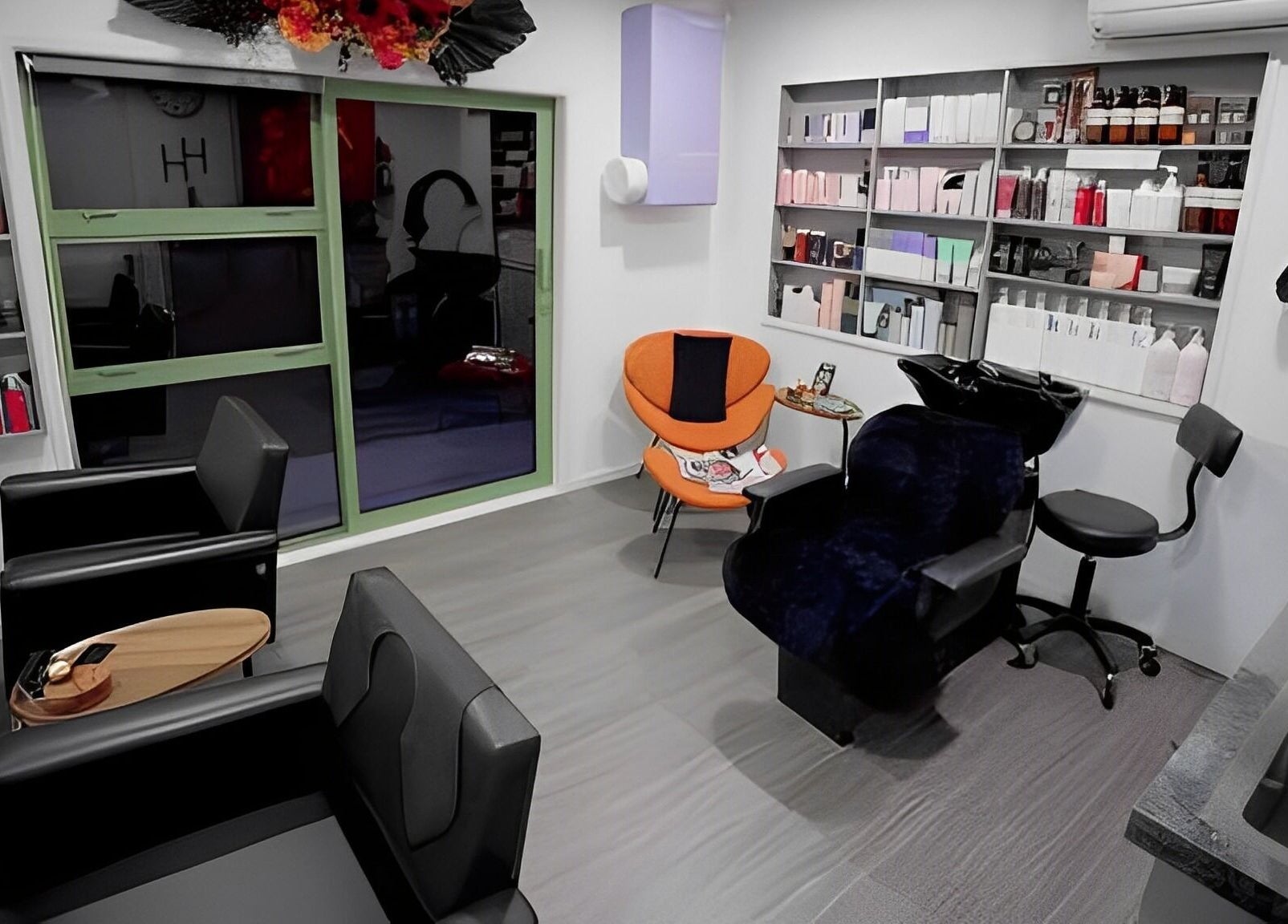 Modern interior of Hair by Hina Limited in Auckland, NZ, featuring sleek chairs and vibrant decor.