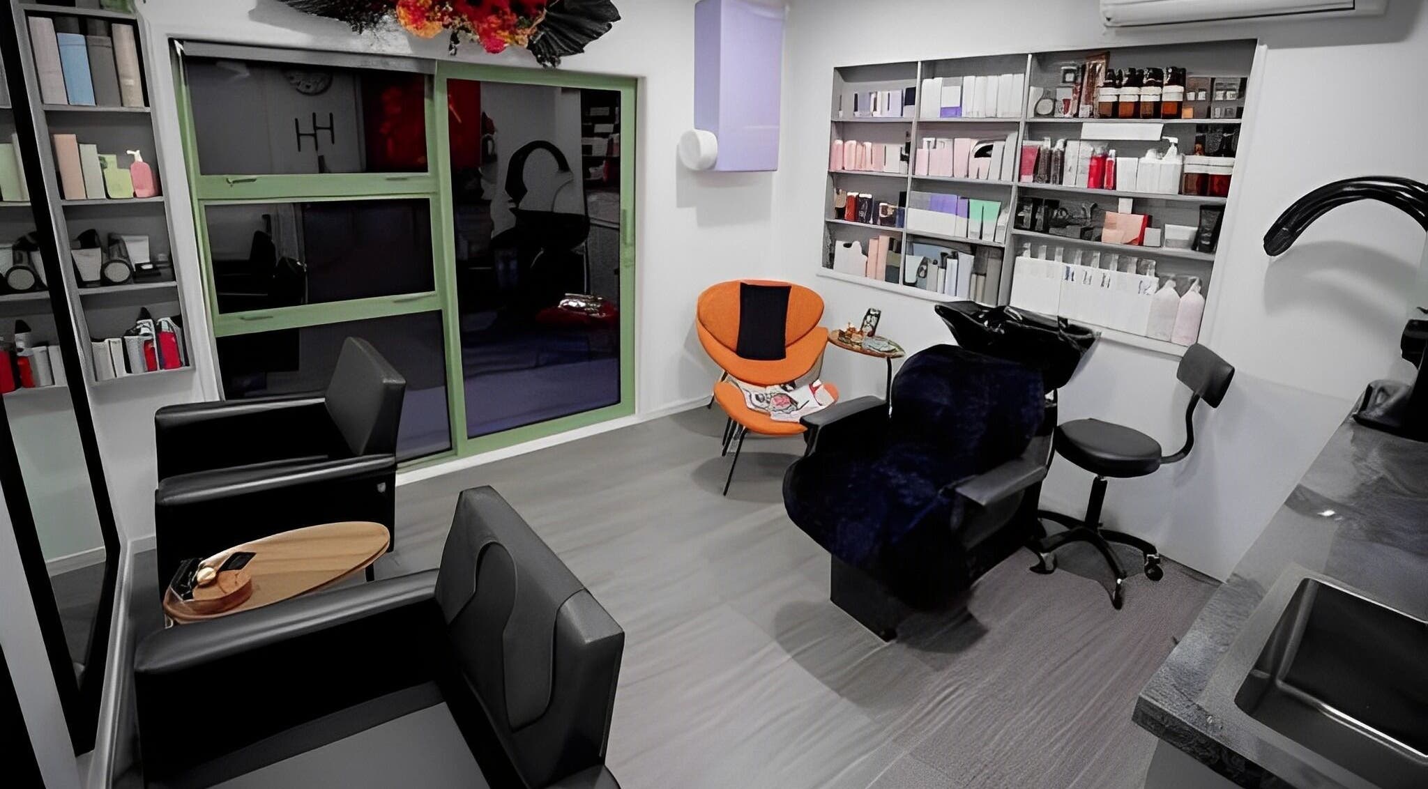 Modern interior of Hair by Hina Limited in Auckland, NZ, featuring sleek chairs and vibrant decor.