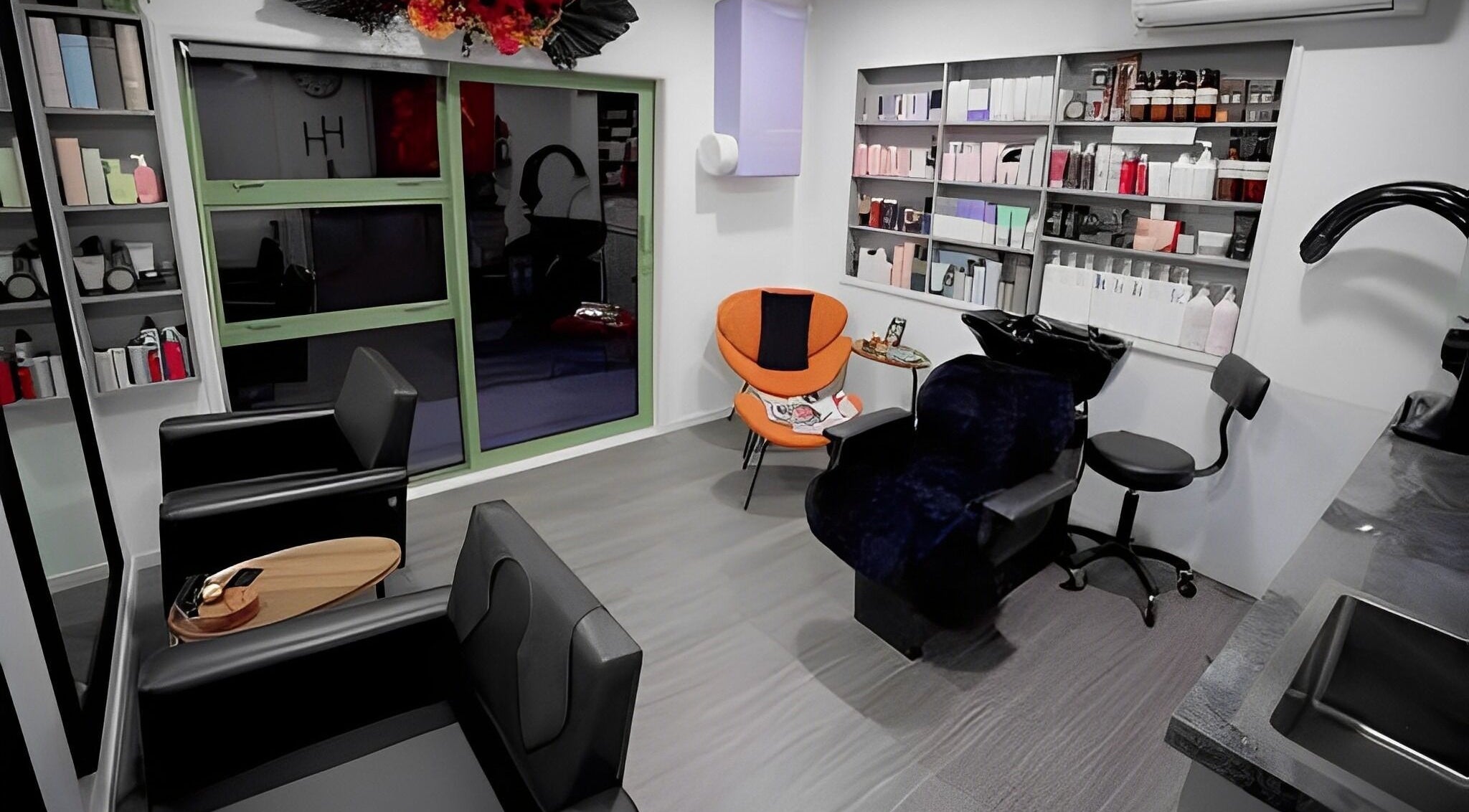 Modern interior of Hair by Hina Limited in Auckland, NZ, featuring sleek chairs and vibrant decor.