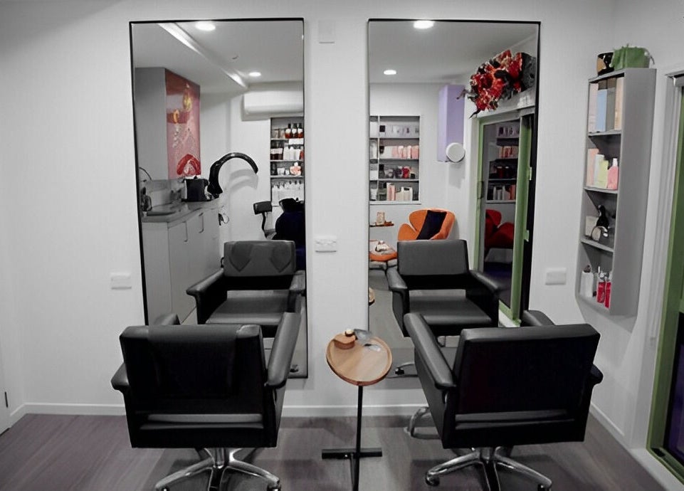 Modern salon interior at Hair by Hina Limited in Auckland, Auckland, NZ, featuring stylish chairs and products.