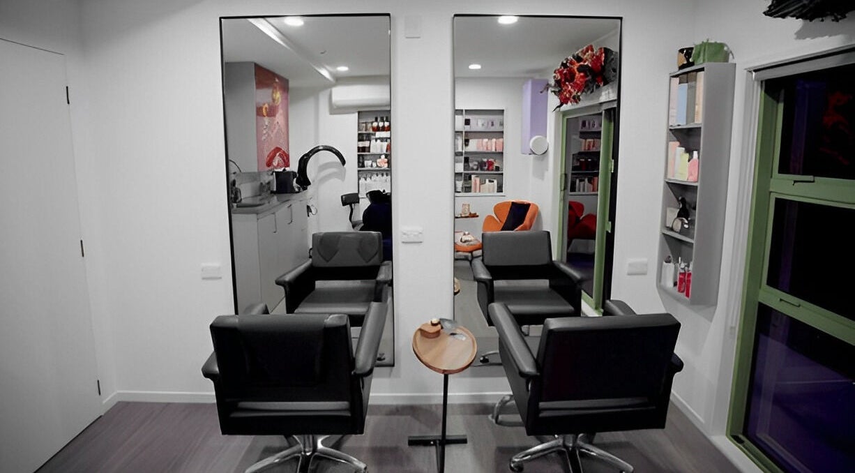 Modern salon interior at Hair by Hina Limited in Auckland, Auckland, NZ, featuring stylish chairs and products.