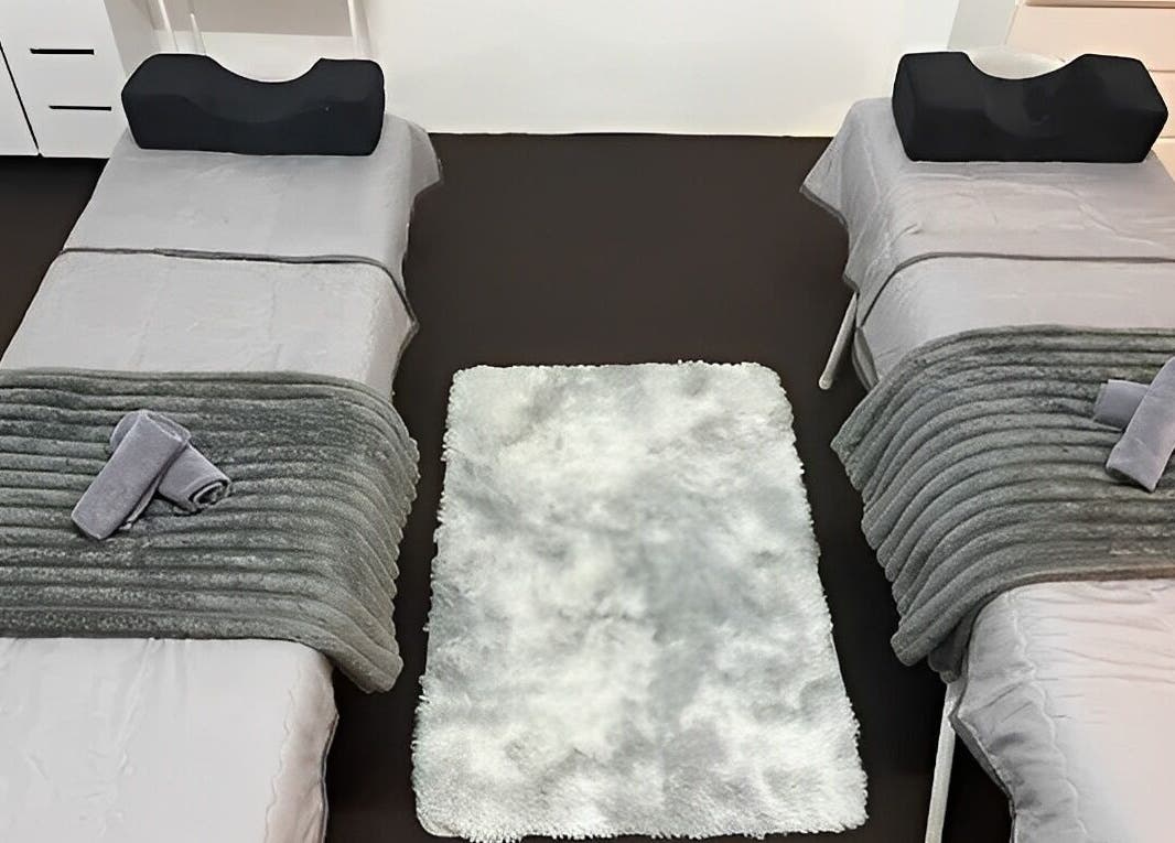 Cozy spa beds at De Elvina Medispa in Muar, Johor, MY, featuring soft towels and elegant decor.