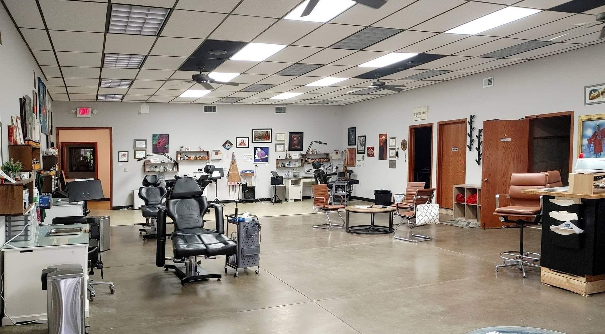 Spacious interior of The Tattooed Lady in Zimmerman, Minnesota, US, featuring modern tattoo stations.