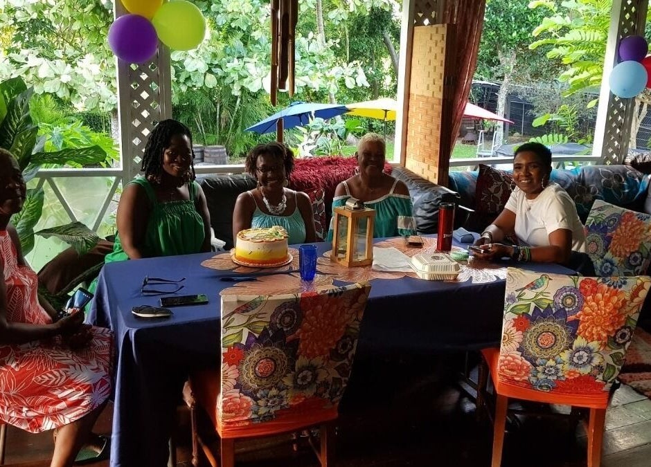 Group enjoying a celebration at Spa Holistic Health and Wellness, St. John, BB, with colorful decor.