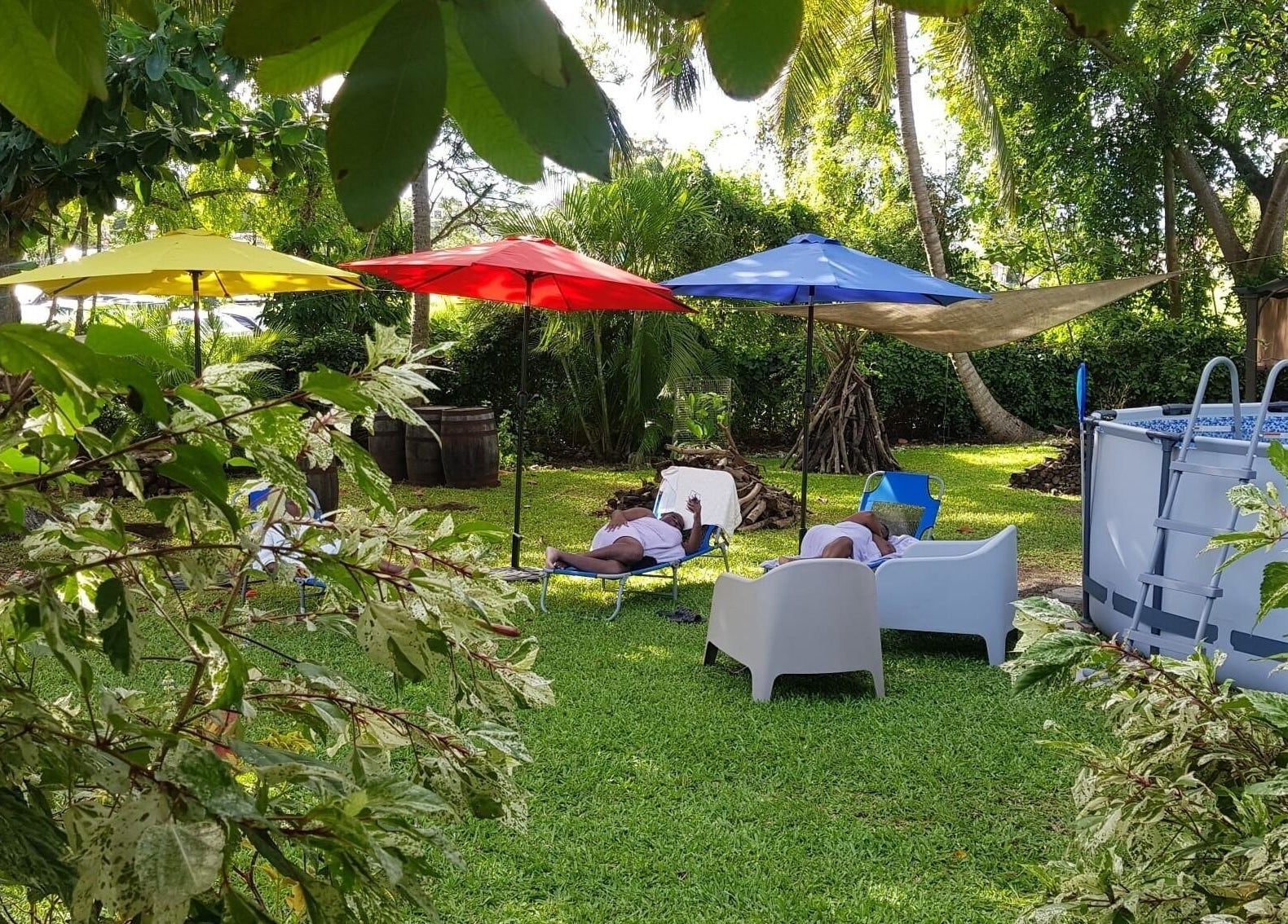 Relaxing garden setting with colorful umbrellas at Spa Holistic Health and Wellness in St. John, BB.