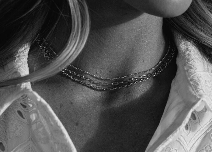 Close-up of a necklace and embroidered blouse at Blush & Brow Beauty, Pointe-claire, Québec, CA.