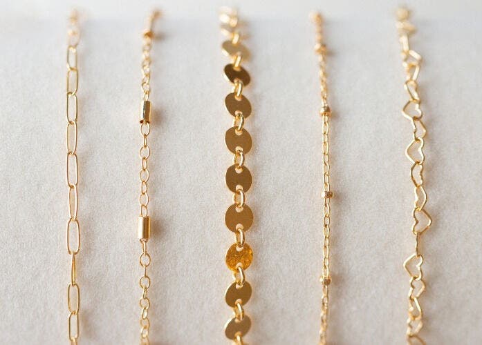 Elegant gold jewelry chains displayed at Blush & Brow Beauty, Pointe-claire, Québec, CA.