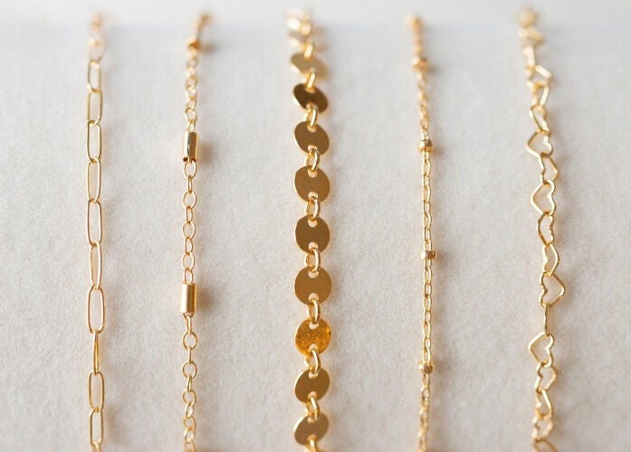 Elegant gold jewelry chains displayed at Blush & Brow Beauty, Pointe-claire, Québec, CA.