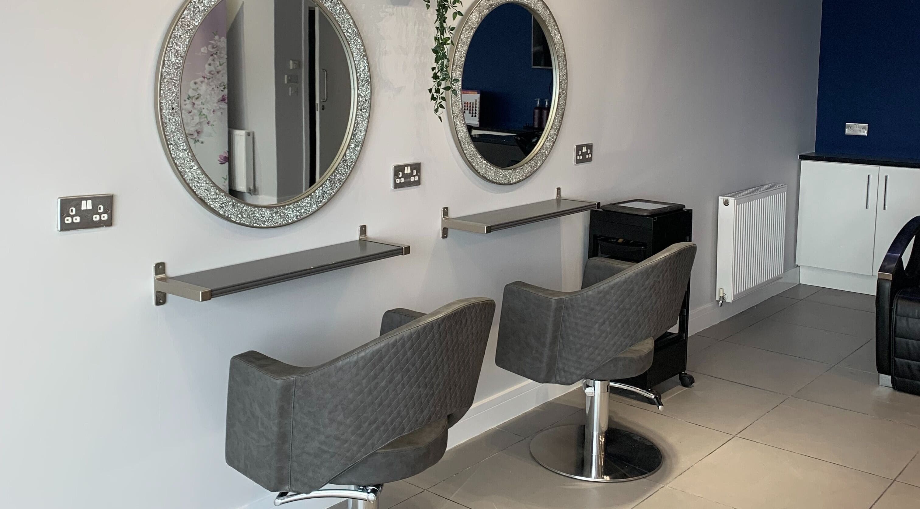 Elegant salon setup at KV Hair, Rotherham, England, GB with stylish chairs and mirrors.