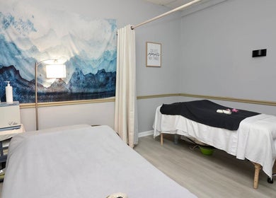 Calming massage room at Spa Wellness Services in Greenacres, Florida, US with serene ocean artwork.