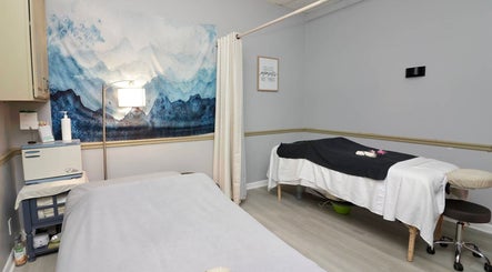 Calming massage room at Spa Wellness Services in Greenacres, Florida, US with serene ocean artwork.